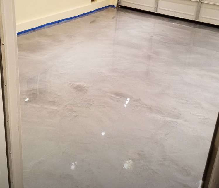 Metallic epoxy floor installed in Conway SC garage — silver gray metallic finish by Bakerss Property Maintenance