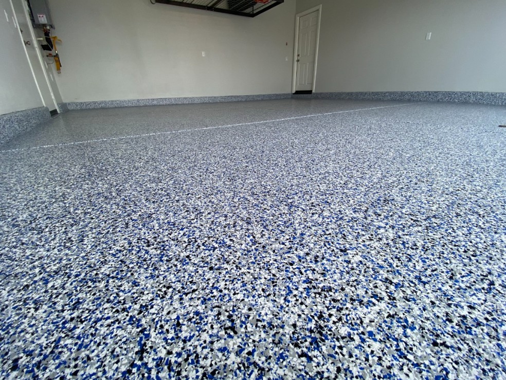 Flake epoxy garage floor in Forest Brook Myrtle Beach SC — blue white black chip system by Bakerss Property Maintenance