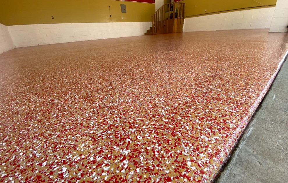Flake epoxy large space floor installed in Loris SC — red tan white chip system by Bakerss Property Maintenance