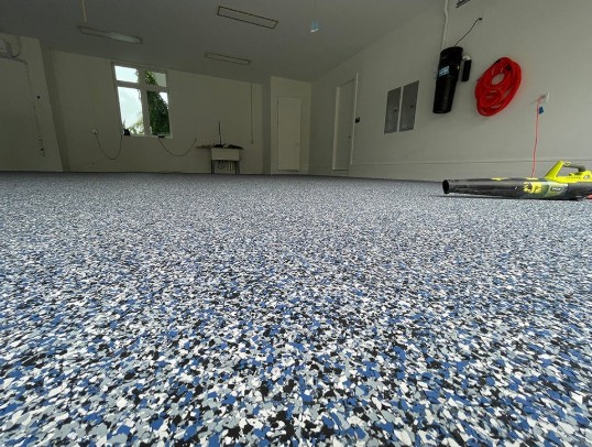 Flake epoxy large garage floor in Murrells Inlet SC — blue white black chip system by Bakerss Property Maintenance