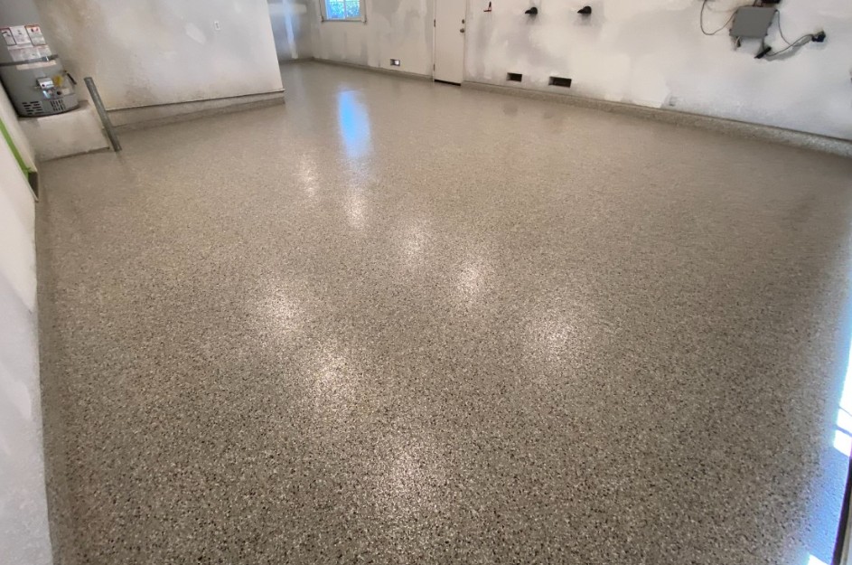 Flake epoxy garage floor installed in North Myrtle Beach SC — warm tan chip system by Bakerss Property Maintenance