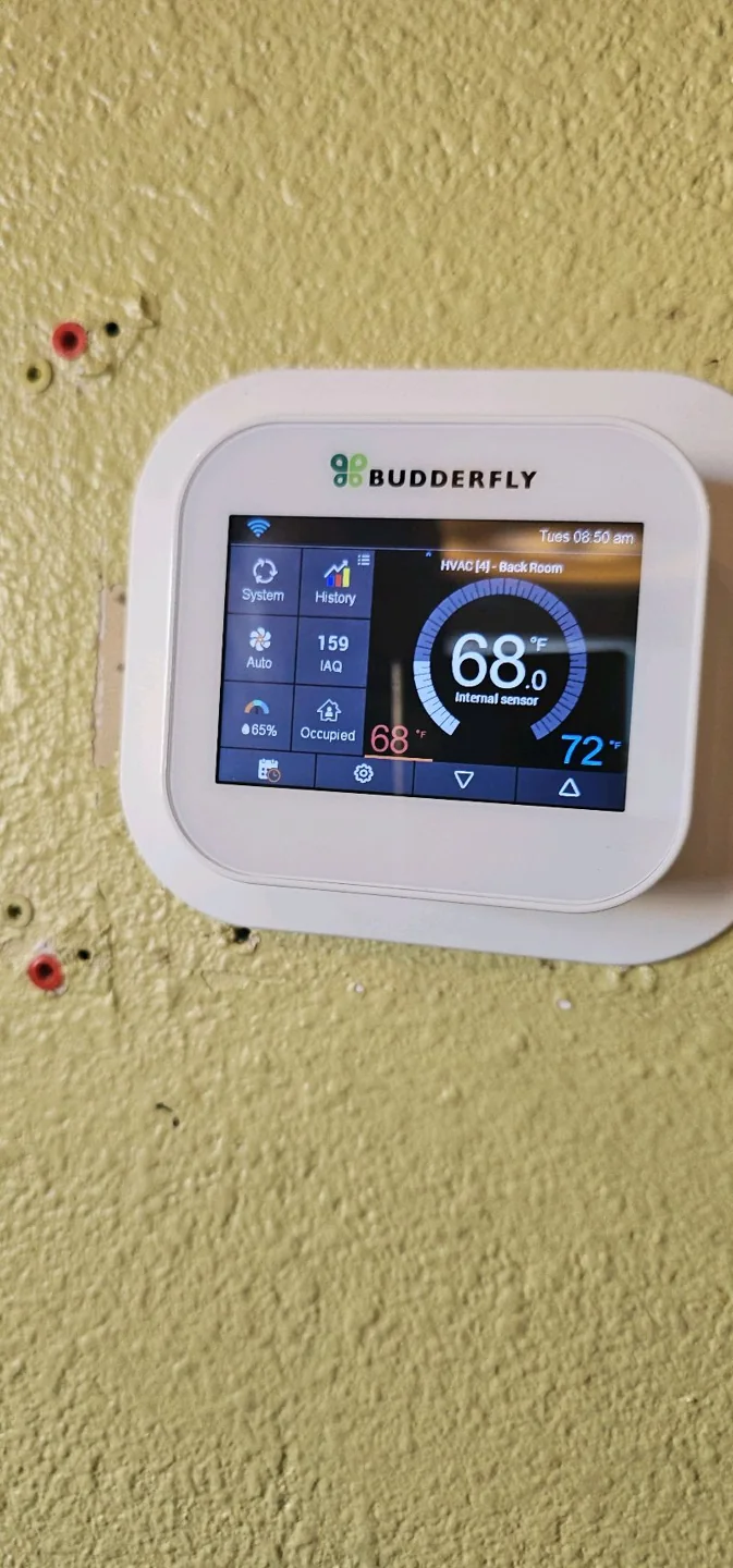 Wall-mounted thermostat during Bakerss service work